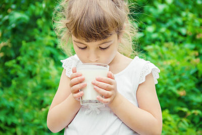 Young woman drinking milk in park