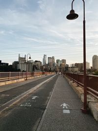 Street lights in city against sky