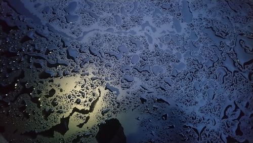 Full frame shot of wet glass window during rainy season