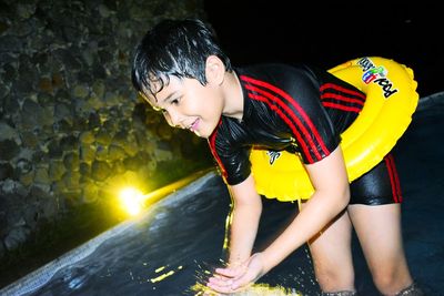 Full length of smiling boy in water