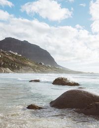 Scenic view of sea and mountains against sky