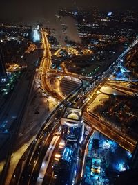 High angle view of illuminated city street and buildings at night