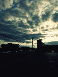 Silhouette of road against cloudy sky