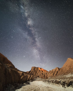 Scenic view of mountains against star field