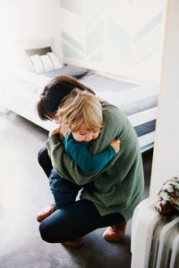 High angle view of woman sitting at home