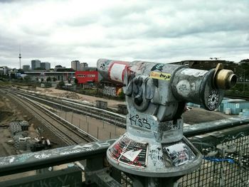 Railroad track against cloudy sky