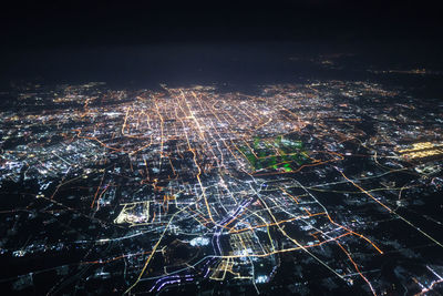 High angle view of illuminated buildings in city at night