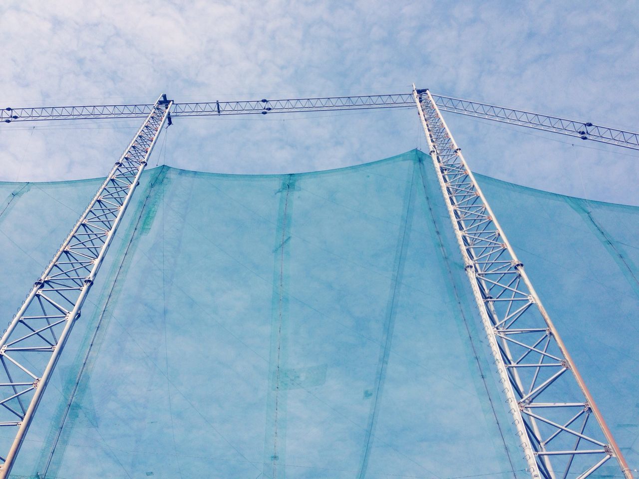 built structure, architecture, sky, low angle view, connection, engineering, cloud - sky, bridge - man made structure, metal, suspension bridge, cloudy, transportation, cloud, outdoors, day, travel destinations, international landmark, famous place, travel, no people