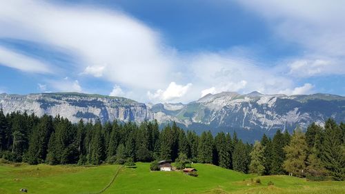 Scenic view of mountains against cloudy sky