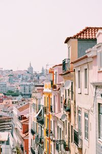 Buildings in city against clear sky