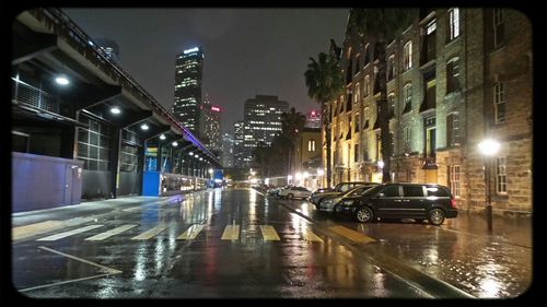 Illuminated street lights in city at night