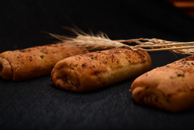 Close-up of bread on table against black background