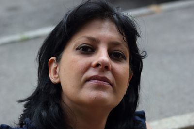 Low angle portrait of mature woman against wall