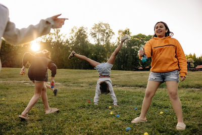 Carefree kids enjoying together while playing in ground at summer camp