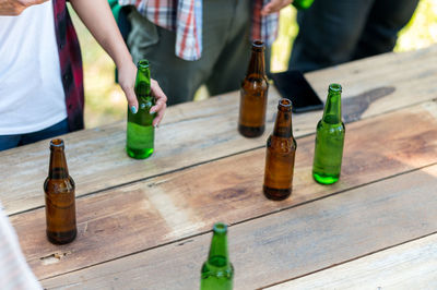 Midsection of wine bottles on table