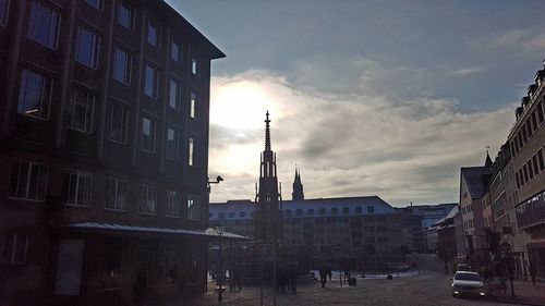 Statue in city at sunset