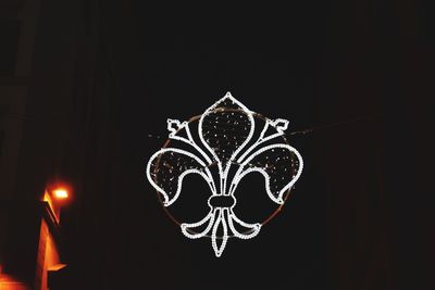 Close-up of illuminated christmas lights against black background