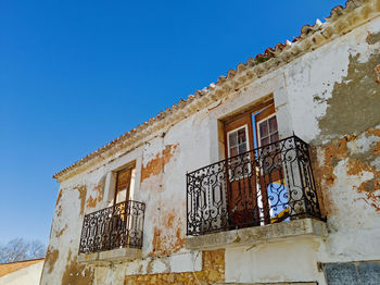 Low angle view of old building against blue sky