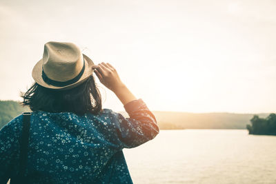 Rear view of woman looking at sea against sky