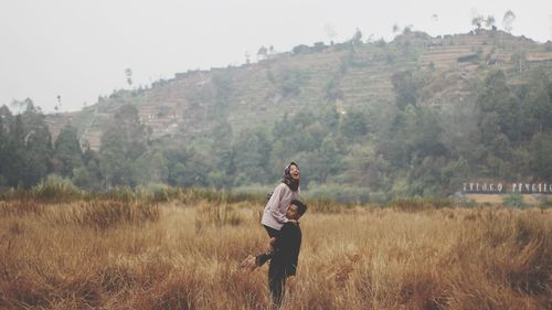 Full length of young man standing on field