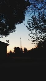 Low angle view of silhouette trees against sky at sunset