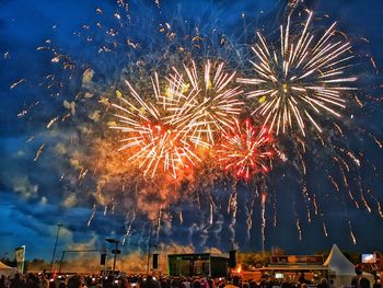 Low angle view of firework display at night