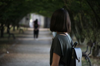 Rear view of couple walking on footpath