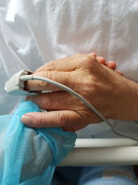 Person holding patient hand in hospital