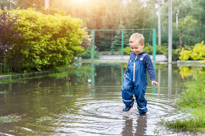 Full length of boy standing in lake