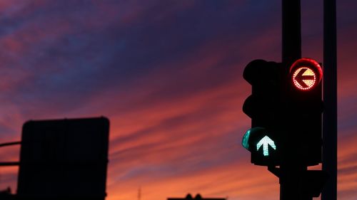 Close-up of road sign at night