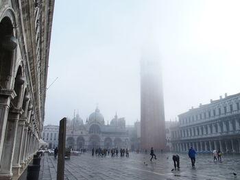 Tourists traveling at saint marks basilica in foggy weather