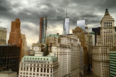 Modern buildings against cloudy sky