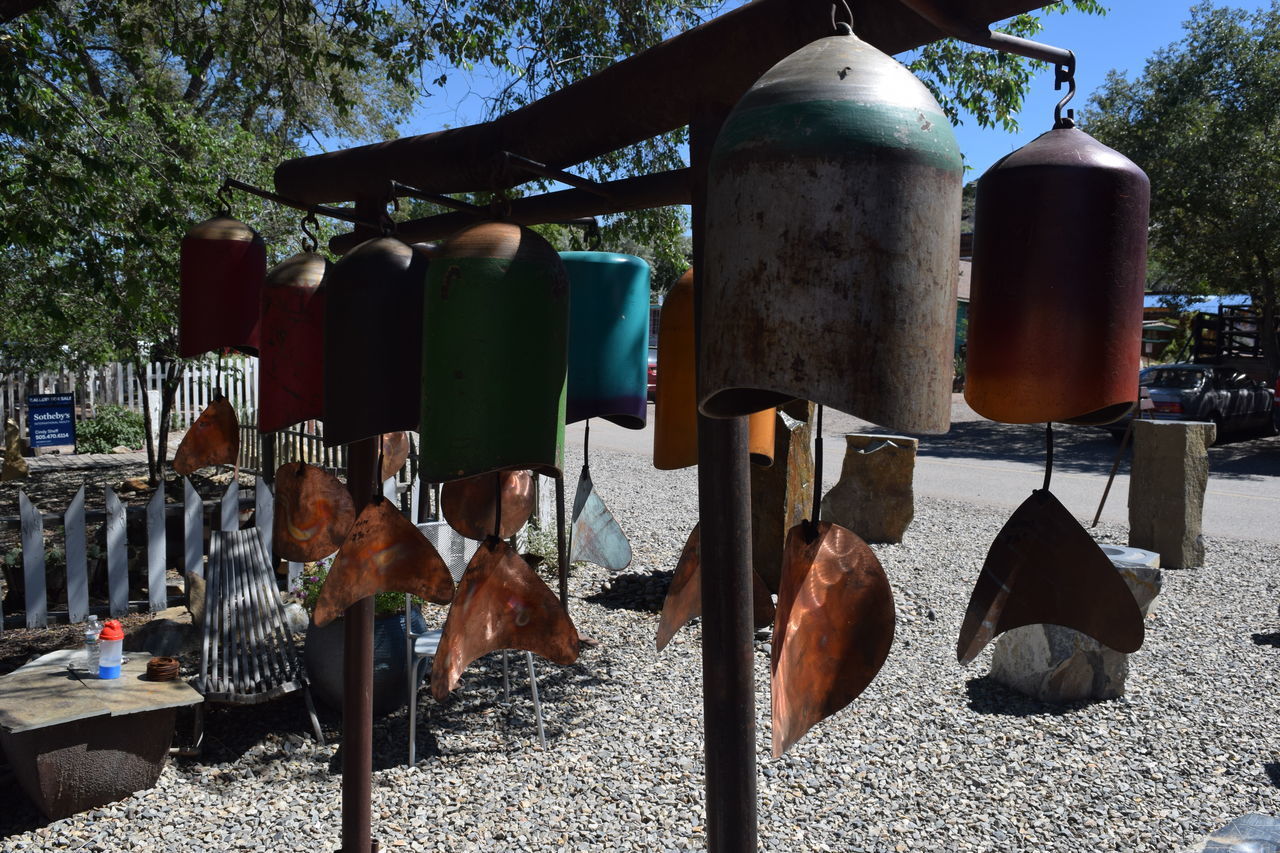 CLOSE-UP OF CLOTHES HANGING ON METAL STRUCTURE