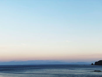 Scenic view of sea against clear sky during sunset