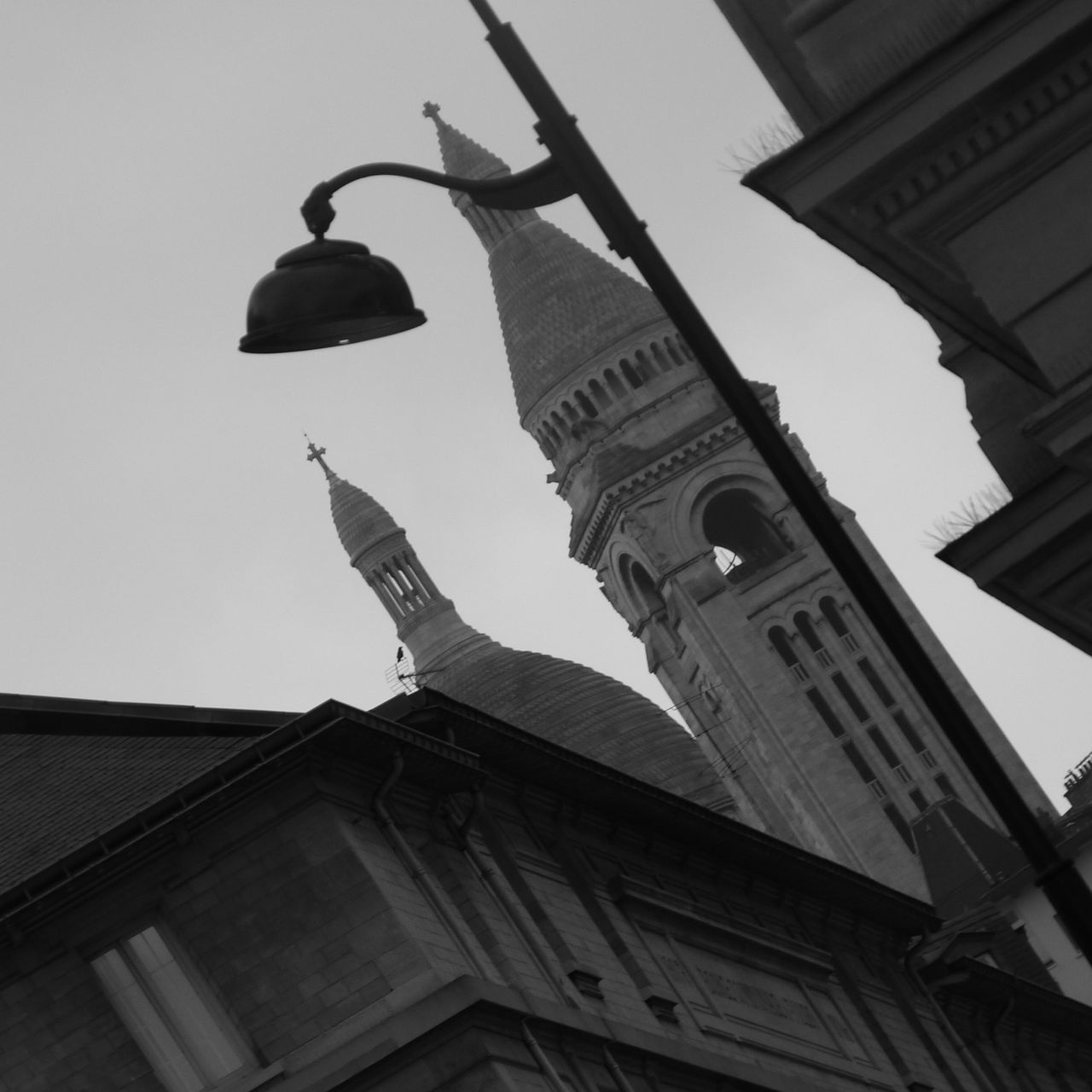 low angle view, architecture, building exterior, built structure, statue, bird, sculpture, art and craft, human representation, art, clear sky, sky, creativity, city, famous place, day, outdoors, no people, history