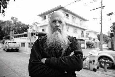 Portrait of man standing on street in city