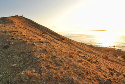 Scenic view of beach against sky during sunset