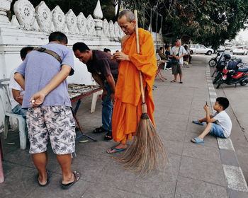 Rear view of friends standing at temple