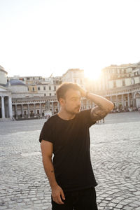 Full length of man standing in city against clear sky