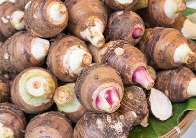 Background of pile of fresh organic taro for retail sale in local morning market departmental store