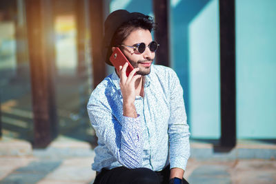 Young man wearing sunglasses standing outdoors