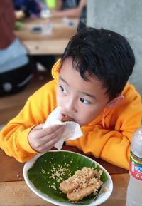 Portrait of cute boy eating food