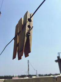 Low angle view of clothes hanging on rope against clear sky