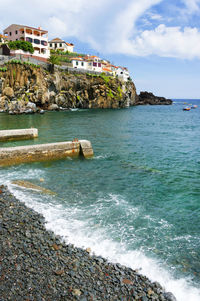 Scenic view of sea against cloudy sky