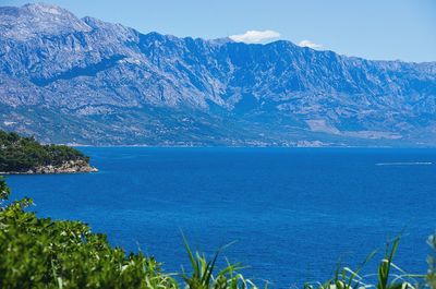 Scenic view of sea against blue sky