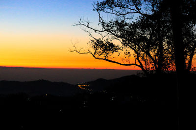 Scenic view of silhouette landscape against romantic sky at sunset