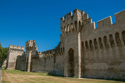 Low angle view of fort against blue sky