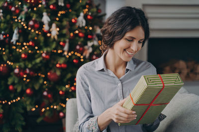 Smiling businesswoman holding gift box