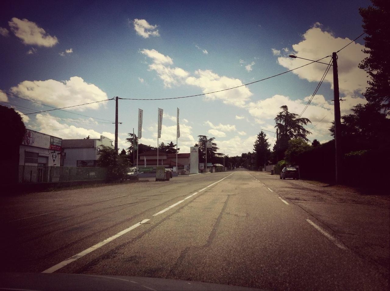 electricity pylon, the way forward, sky, power line, road, building exterior, transportation, electricity, diminishing perspective, street, vanishing point, built structure, power supply, fuel and power generation, cloud - sky, architecture, cloud, street light, empty, house