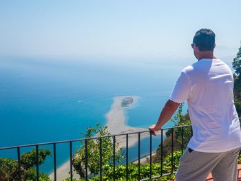 Man looking at sea against sky